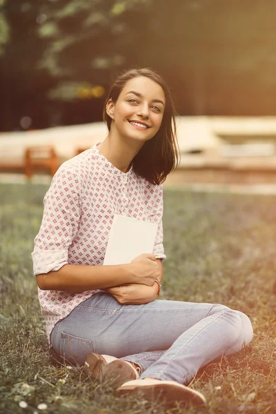 Beautiful girl holding an open book — Stock Photo, Image