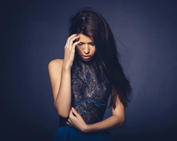 Attractive girl with flying hair posing in studio — Stock Photo, Image