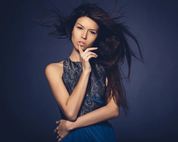 Attractive girl with flying hair posing in studio — Stock Photo, Image