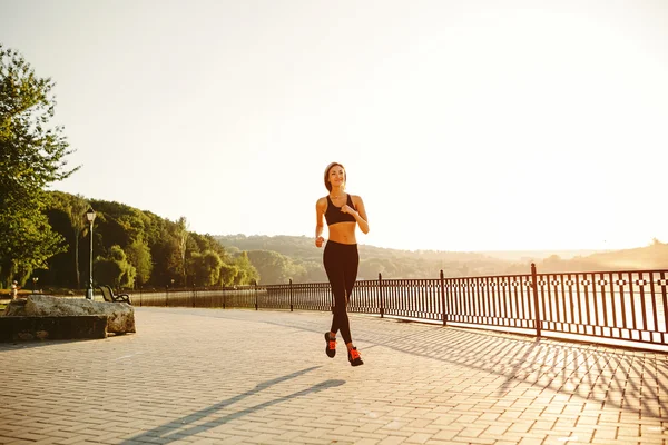 Running woman. Runner jogging in sunny bright light. Female fitn — Stock Photo, Image