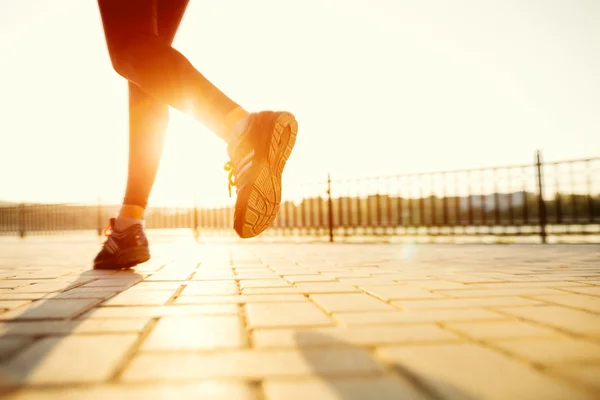 Runner feet running on road closeup on shoe. woman fitness sunri — Stock Photo, Image