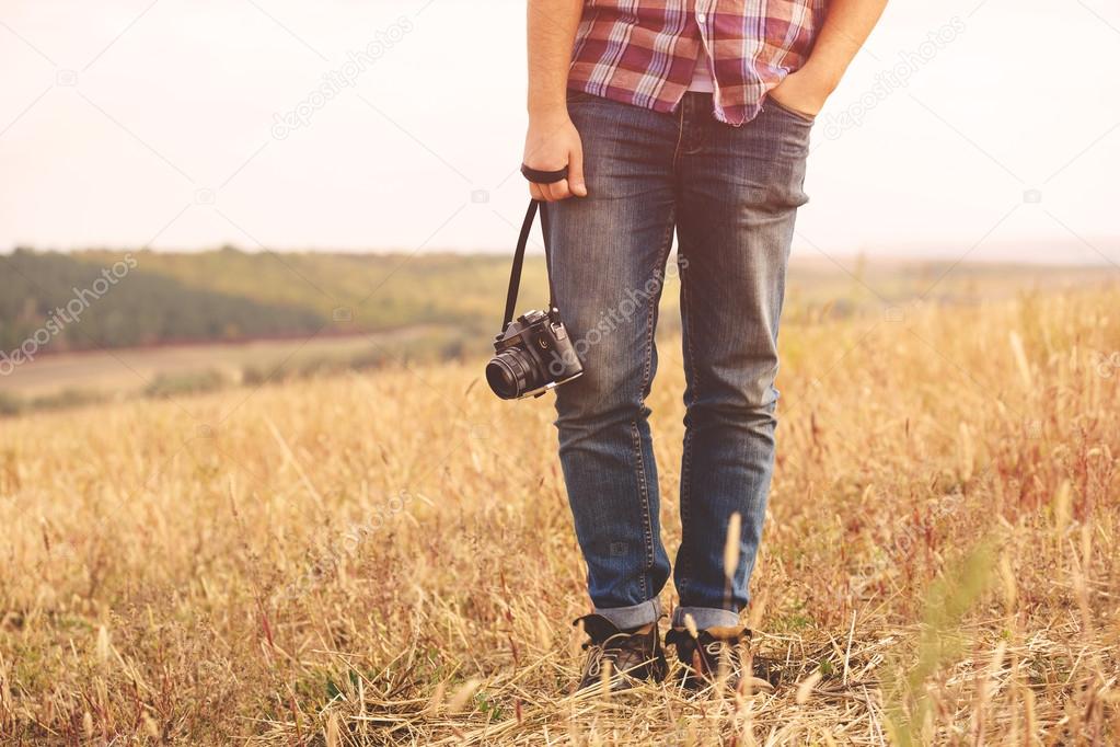 Young Man with retro photo camera outdoor hipster Lifestyle