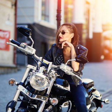 Motorcu kız bir motosiklet üzerinde bir deri ceketli