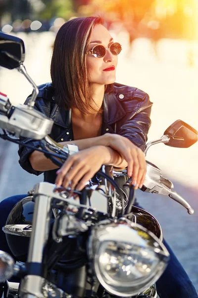 Chica motorista en una chaqueta de cuero en una motocicleta — Foto de Stock