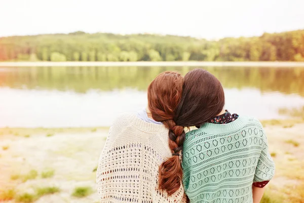 Two sisters with interwoven hairs — Stock Photo, Image