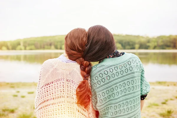 Two sisters with interwoven hairs — Stock Photo, Image