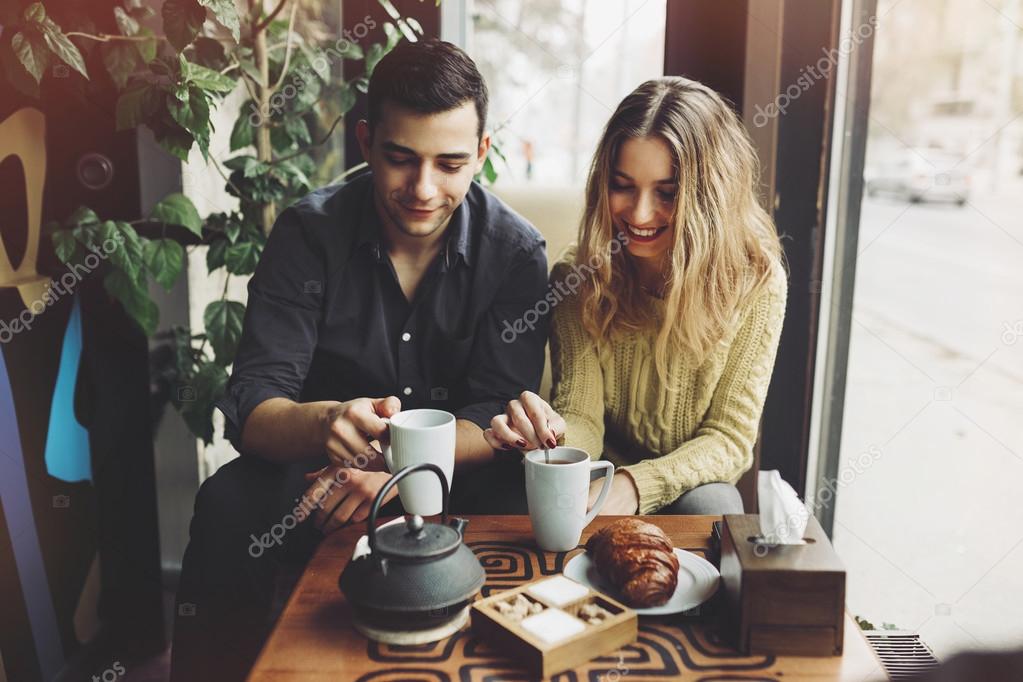 Couple in love drinking coffee in coffee shop