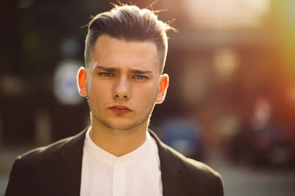 Portrait of young man with a backpack on his back — Stock Photo, Image