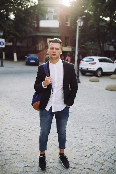 Portrait of young man with a backpack on his back — Stock Photo, Image