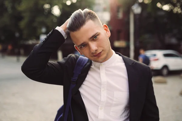 Portrait of young man with a backpack on his back — Stock Photo, Image