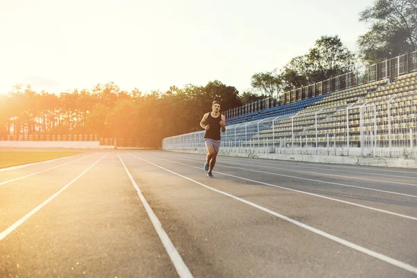 Man running on a racing track — Stock Photo, Image