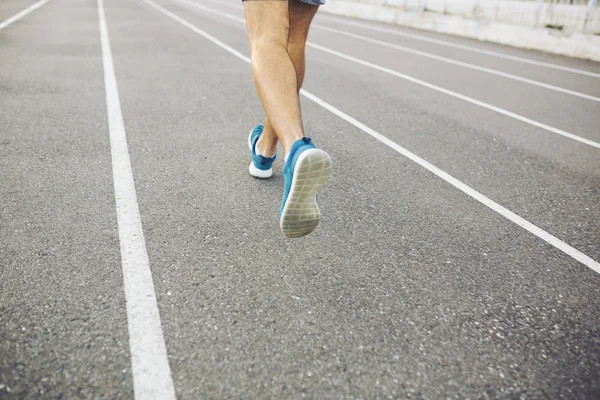 Man running on a racing track — Stock Photo, Image