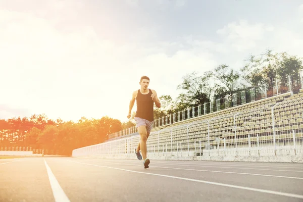 Man running on a racing track — Stock Photo, Image