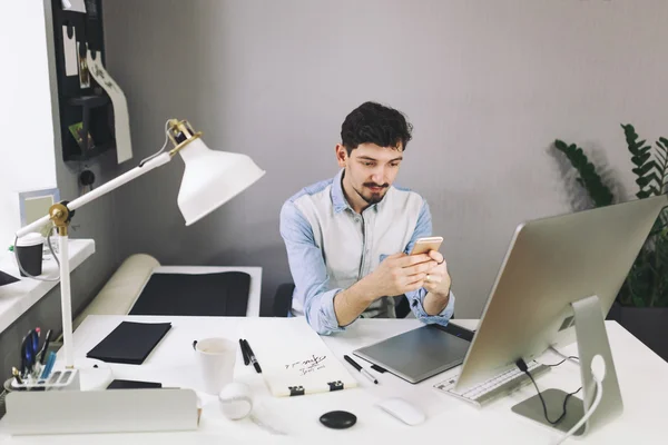 Handsome businessman working in office using mobile phone — Stock Photo, Image