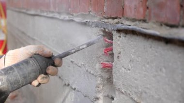 İnşaat işi. Yumruklayıcı betonda delikler açıyor..