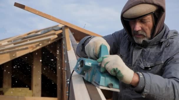 Een boom schaven met een elektrische schaafmachine. Menselijke emotie. Hard werken. — Stockvideo