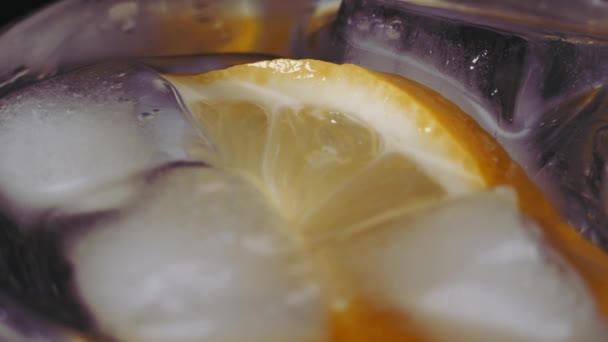 Primer plano de agua de vidrio con lima, limón. Soda con rodajas de limón y hielo para desintoxicar. concepto de frescura. — Vídeos de Stock