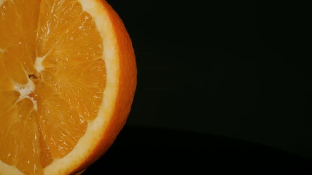 Orange on a black background. — Stock Video
