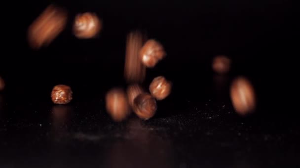 Chocolate balls.Chocolate corn cereal balls moving up and down on a black background. — Stock Video