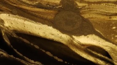 Sıvı Sanat. Şeffaf bir arkaplanda altın ve gümüş tozu. Soyut hareketli arkaplan.