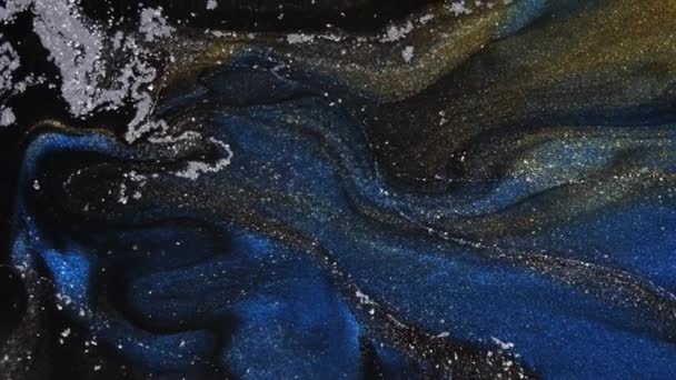 Fluid art. Black background with blue and gold stripes. Moving particles. — Stock Video