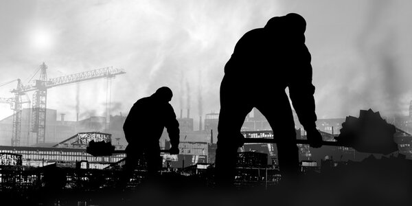 Group of silhouettes carry coal