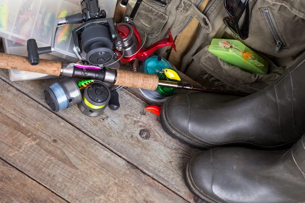Fishing tackles with fishing vest and boots — Stock Photo, Image