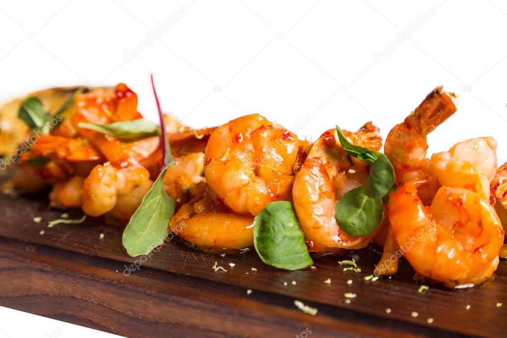roasted hulled shrimps with leafs on dark wooden