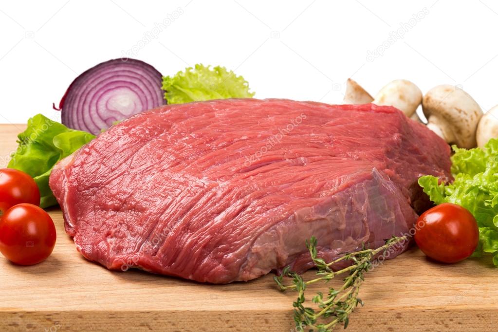 pice of fresh raw meat with vegetables