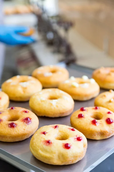 Doughnuts with assorted filling on metal tray — Stock Photo, Image
