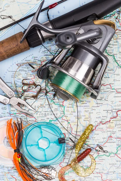 Fishing tackles - rod, reel, line and lure on map — Stock Photo, Image