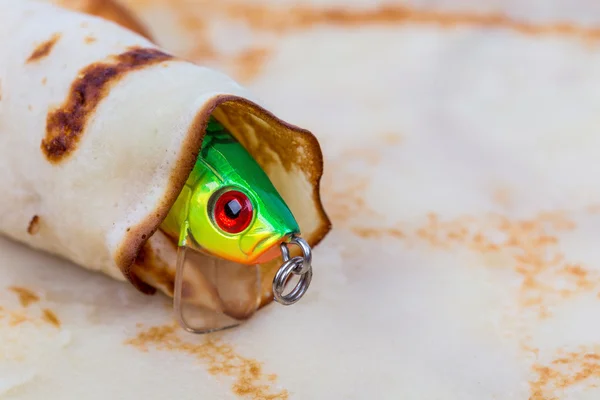 Fishing tackle lure rolled in pancake — Stock Photo, Image