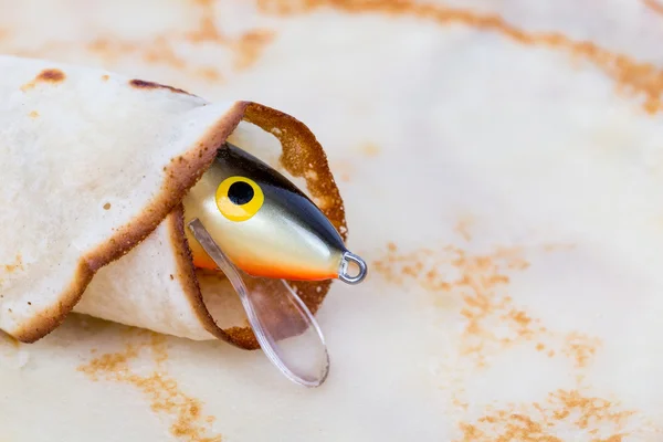 Fishing tackle lure rolled in pancake — Stock Photo, Image