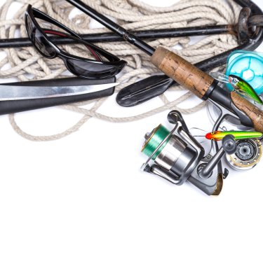 fishing tackles and anchor with cord on white