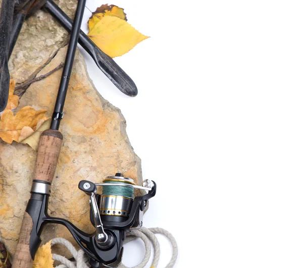 Fishing rods on stones with anchor and leafs — Stockfoto