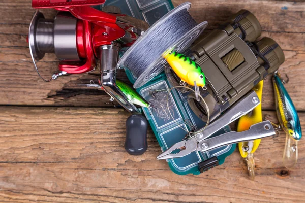 Fishing and tourism gear on timber board — Stock Photo, Image