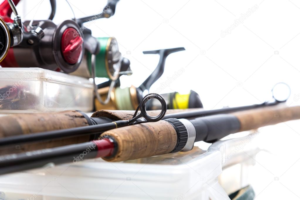 fishing reels and rods on storage boxes