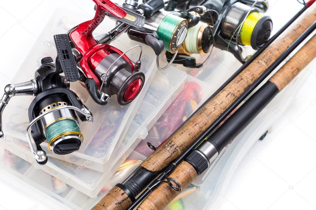 fishing reels and rods on storage boxes