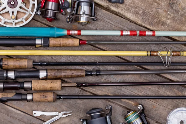 Canne da pesca e mulinelli su tavole di legno — Foto Stock