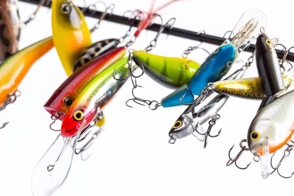 Colored fishing bait wobblers be suspended on rod`s blank — Stock Photo, Image