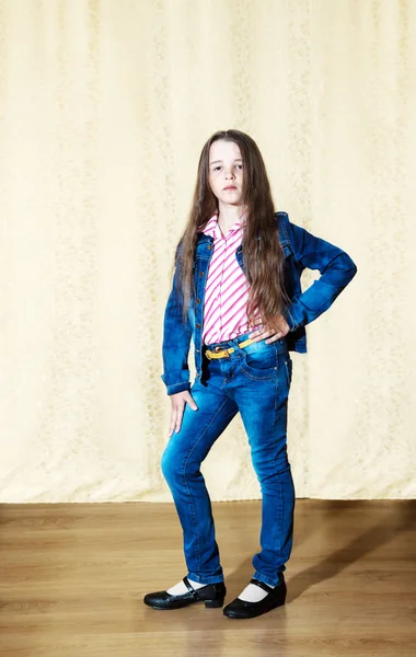 Liten flicka med långt hår i en blå denim kostym — Stockfoto