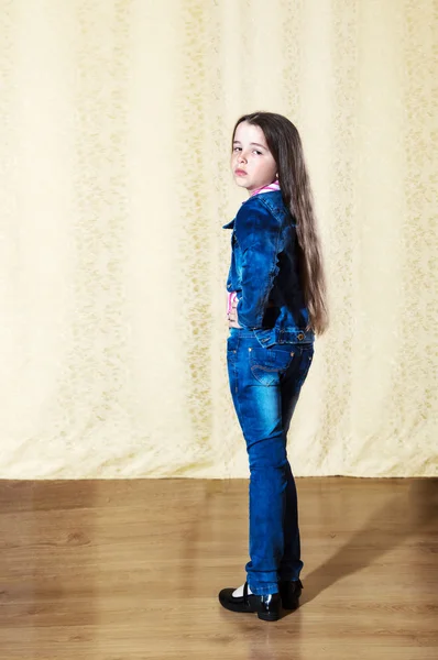 Little girl with long hair in a blue denim suit — Stock Photo, Image