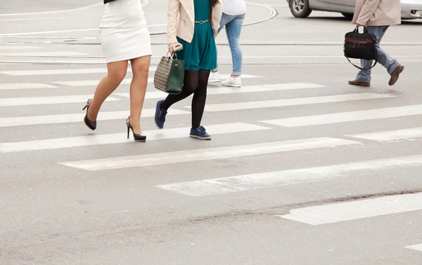 women's legs on a pedestrian crossing closeup