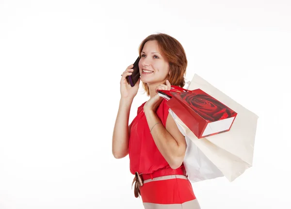 Alışveriş torbaları cep telefon ederken kızla — Stok fotoğraf
