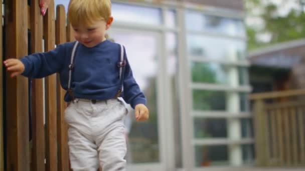 Boy playing with sister outdoors — Stock Video