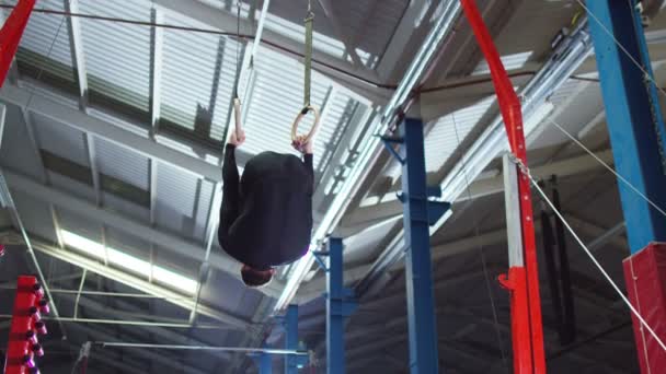 Gymnast training on the rings — Stock Video