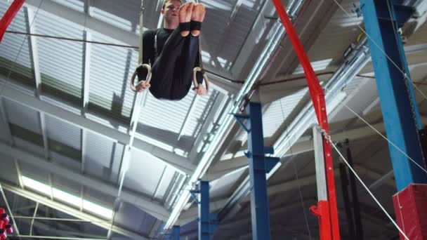 Gymnast training on the rings — Stock Video