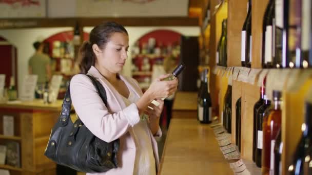 Woman looking at wine — Stock Video