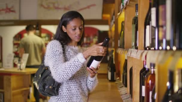 Woman looking at wine — Stock Video