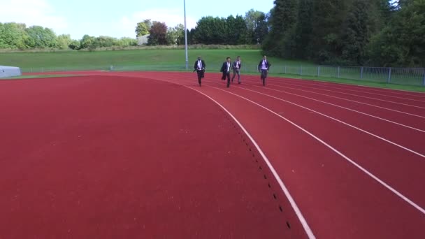 businessmen racing each other at running track